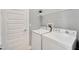 Bright laundry room with washer, dryer, and shelving at 567 Bimini Bay Blvd, Apollo Beach, FL 33572
