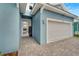 Front entryway of light blue home with white door and paver walkway at 567 Bimini Bay Blvd, Apollo Beach, FL 33572