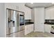 Modern kitchen with stainless steel refrigerator and white cabinets at 567 Bimini Bay Blvd, Apollo Beach, FL 33572
