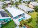 Aerial view showcasing a house with a pool, solar panels, and its surrounding neighborhood at 567 Bimini Bay Blvd, Apollo Beach, FL 33572