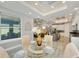 Open dining room with glass table and view into kitchen at 567 Bimini Bay Blvd, Apollo Beach, FL 33572