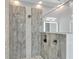 Modern shower with gray tile and a built-in shelf at 567 Bimini Bay Blvd, Apollo Beach, FL 33572