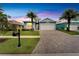 Two-story home with a light blue exterior, palm trees and driveway at 567 Bimini Bay Blvd, Apollo Beach, FL 33572