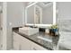 Bathroom with floating sink, granite countertop, and illuminated mirror at 567 Bimini Bay Blvd, Apollo Beach, FL 33572
