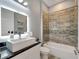 Clean bathroom with shower/tub combo, modern vanity, and gray tile at 567 Bimini Bay Blvd, Apollo Beach, FL 33572