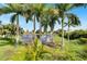 Peaceful backyard with pond view and lush tropical landscaping at 567 Bimini Bay Blvd, Apollo Beach, FL 33572