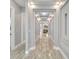 Long hallway with tile floors and recessed lighting, leading to living room at 567 Bimini Bay Blvd, Apollo Beach, FL 33572