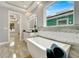 Elegant bathroom with soaking tub, walk-in shower, and modern vanity at 567 Bimini Bay Blvd, Apollo Beach, FL 33572