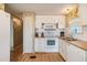 White kitchen with wood flooring and built in microwave at 37743 Mission Hills Ave, Zephyrhills, FL 33541