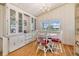 Cozy dining area with white built-in hutch and wood floors at 37743 Mission Hills Ave, Zephyrhills, FL 33541
