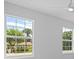 Well-lit bedroom with two large windows and garden view at 6999 Burnsville St, Englewood, FL 34224