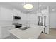 Modern kitchen with white shaker cabinets, stainless steel appliances, and a large island at 6999 Burnsville St, Englewood, FL 34224