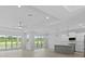 Open living space featuring high ceilings, hardwood floors, and access to the backyard at 6999 Burnsville St, Englewood, FL 34224
