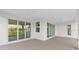Covered back patio with sliding glass doors at 6999 Burnsville St, Englewood, FL 34224