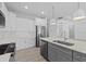 Modern kitchen with white cabinets, quartz countertops and stainless steel appliances at 6999 Burnsville St, Englewood, FL 34224