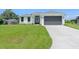 Modern home exterior with two-car garage and manicured lawn at 6999 Burnsville St, Englewood, FL 34224