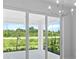 Bright dining room with sliding glass doors leading to a view of the backyard at 6999 Burnsville St, Englewood, FL 34224
