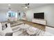 Bright open-plan living and dining area with hardwood floors and stylish modern furnishings at 1028 Apollo Beach Blvd # 4, Apollo Beach, FL 33572