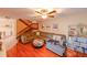 Living room with hardwood floors, sectional sofa, and a view of the staircase at 12703 Tall Pine Dr, Tampa, FL 33625