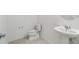 A clean, well-lit half bathroom with a white sink and toilet offers comfort and convenience at 4255 Big Sky Dr, Spring Hill, FL 34604