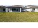 A well-manicured backyard features a covered patio and plenty of green space for outdoor enjoyment at 4265 Big Sky Dr, Spring Hill, FL 34604