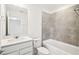 Bathroom featuring a tub with tiled wall, vanity with light counter, and neutral tiled floors at 4265 Big Sky Dr, Spring Hill, FL 34604