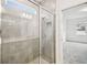 Modern bathroom with glass enclosed shower featuring decorative tile and a linen closet nearby at 4265 Big Sky Dr, Spring Hill, FL 34604