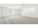 This expansive loft area features neutral carpet, recessed lighting, and large windows at 4265 Big Sky Dr, Spring Hill, FL 34604