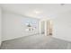 Spacious main bedroom with plush carpeting and a view of an attached bathroom and walk-in closet at 4265 Big Sky Dr, Spring Hill, FL 34604