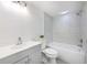 Modern bathroom with gray vanity, marble tile shower, and bathtub at 1028 Apollo Beach Blvd # 4, Apollo Beach, FL 33572