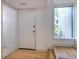 Light and airy condo entryway with wood floors and built-in bench at 1028 Apollo Beach Blvd # 4, Apollo Beach, FL 33572