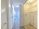 Clean hallway with access to bedroom and laundry area at 1028 Apollo Beach Blvd # 4, Apollo Beach, FL 33572