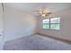 Bright bedroom with carpeted floor, ceiling fan, and large window at 1028 Apollo Beach Blvd # 4, Apollo Beach, FL 33572