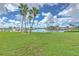 Backyard with grassy area, palm trees, and waterfront view at 1028 Apollo Beach Blvd # 4, Apollo Beach, FL 33572