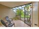 Relaxing screened porch with patio furniture overlooking the garden at 1028 Apollo Beach Blvd # 4, Apollo Beach, FL 33572