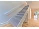Modern staircase with light grey carpeting and white railings at 1028 Apollo Beach Blvd # 4, Apollo Beach, FL 33572