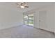 Comfortable bedroom with grey carpeting and access to a private balcony at 1028 Apollo Beach Blvd # 4, Apollo Beach, FL 33572