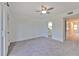 Spacious bedroom with grey carpet and access to a hallway bathroom at 1028 Apollo Beach Blvd # 4, Apollo Beach, FL 33572