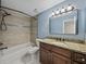 Updated bathroom with granite countertop, wood cabinets, and tile shower/tub combo at 4317 Honey Vista Cir, Tampa, FL 33624