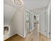 Long hallway with light walls and wood-look floors, showing access to other rooms at 4317 Honey Vista Cir, Tampa, FL 33624