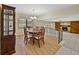 Open dining area with hardwood floors and a view of the living room and fireplace at 4317 Honey Vista Cir, Tampa, FL 33624