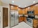 Well-equipped kitchen with stainless steel appliances and wood cabinetry at 4317 Honey Vista Cir, Tampa, FL 33624