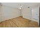 Bedroom with wood-look floors, mirrored closet, and ceiling fan at 4317 Honey Vista Cir, Tampa, FL 33624