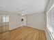 Bright bedroom with wood-look floors and mirrored closet doors at 4317 Honey Vista Cir, Tampa, FL 33624