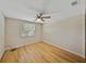 Well-lit bedroom with neutral walls, ceiling fan, and wood flooring at 4317 Honey Vista Cir, Tampa, FL 33624