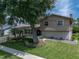 House exterior showcasing landscaping and a large tree in the front yard at 4317 Honey Vista Cir, Tampa, FL 33624