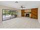 Gathering room with tile floors, stone fireplace, and pool view at 4317 Honey Vista Cir, Tampa, FL 33624