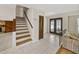Bright entryway with tiled floors, wooden staircase, and double doors at 4317 Honey Vista Cir, Tampa, FL 33624