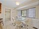 Bright breakfast nook with glass-top table and four chairs at 4317 Honey Vista Cir, Tampa, FL 33624