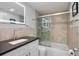 Stylish bathroom features a sleek vanity with black countertop and a shower with decorative tiles at 1819 Shore S Dr # 318, South Pasadena, FL 33707